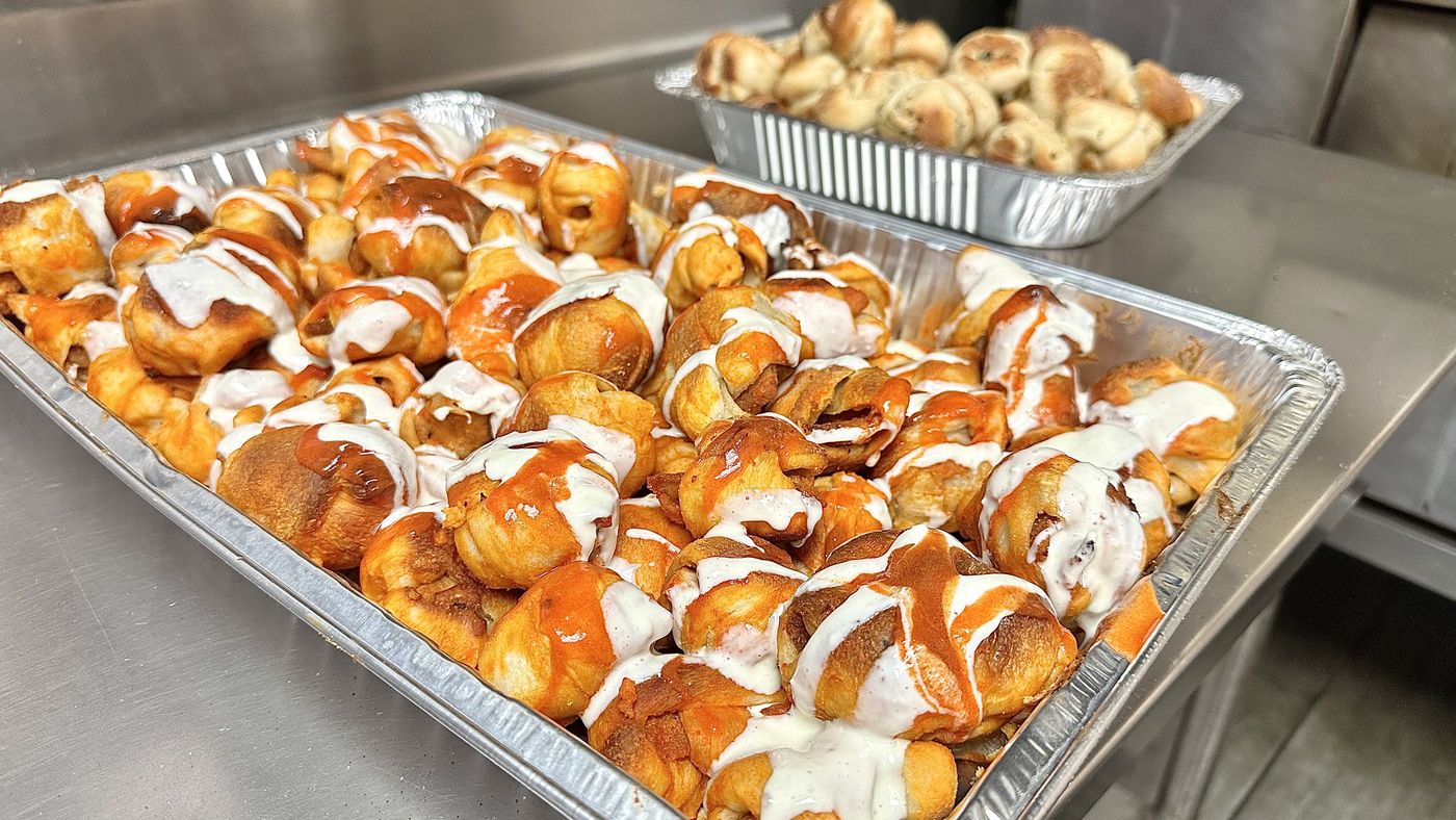 Catering trays of buffalo chicken knots and garlic knots