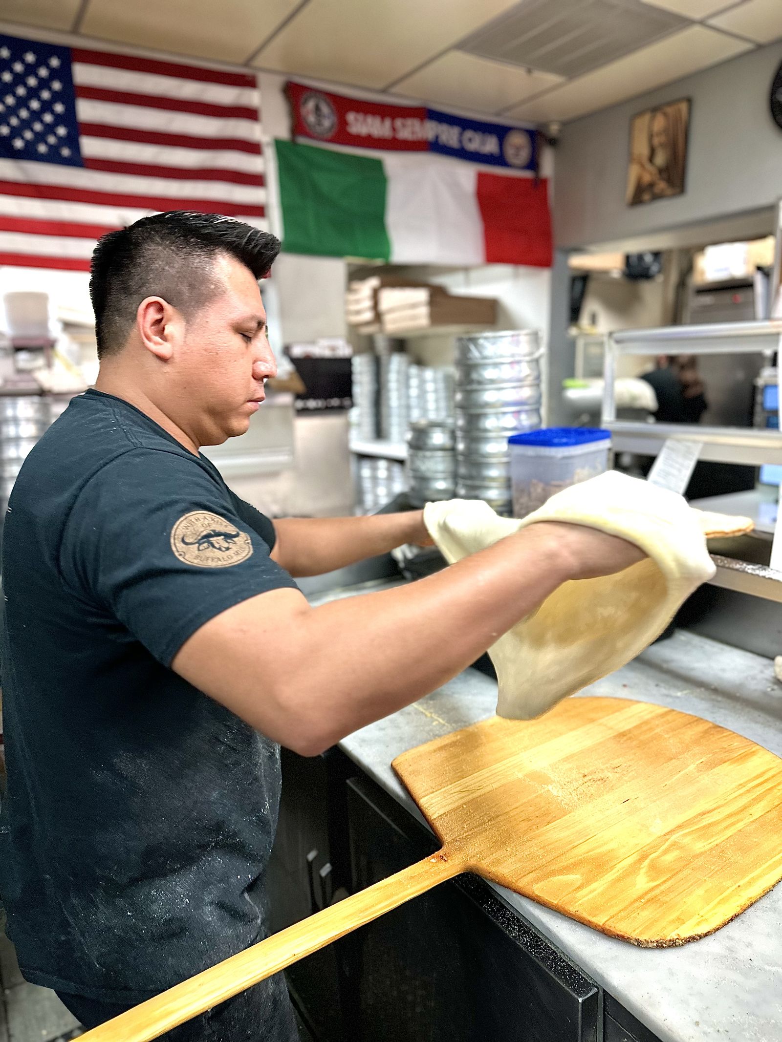A Phillippo's pizzaiolo hand-tossing fresh dough